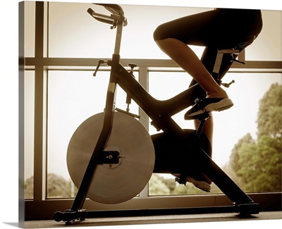Woman riding exercise bike