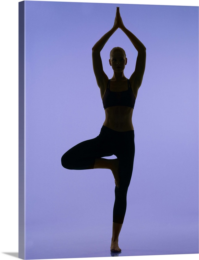 girl doing yoga stretches in silouette on purple background