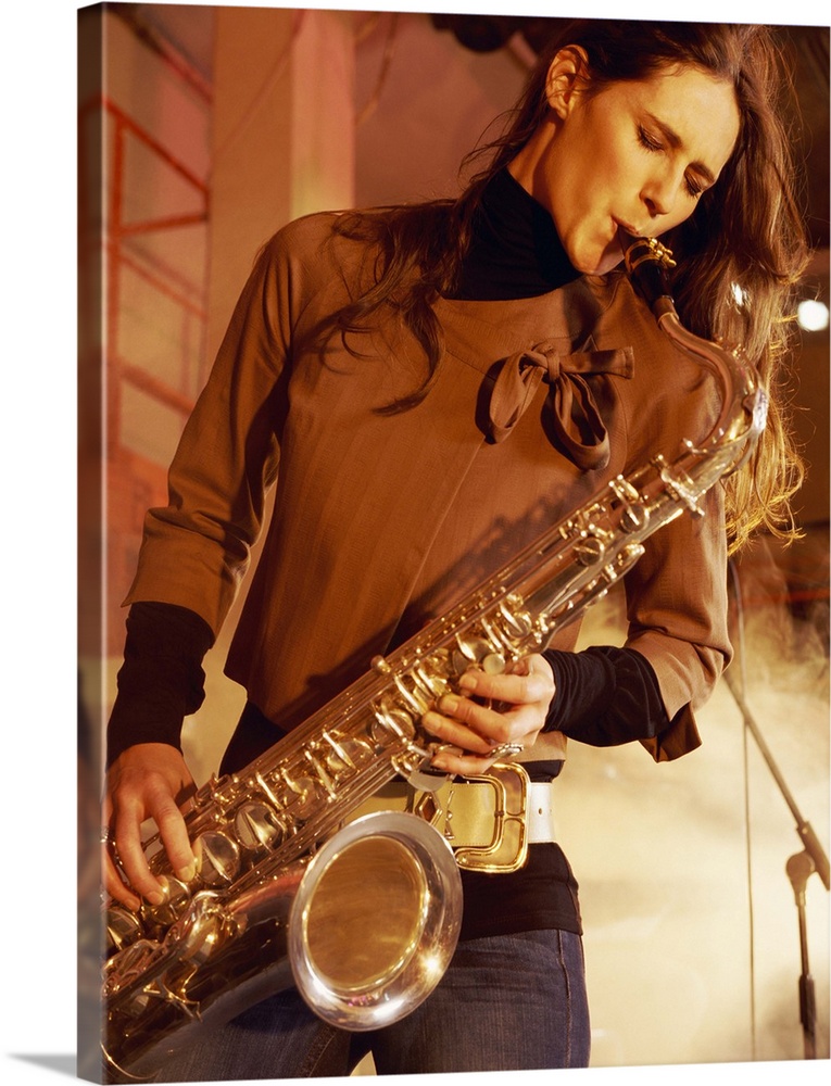 Woman Stands on a Smoky Stage Playing a Saxophone With Passion