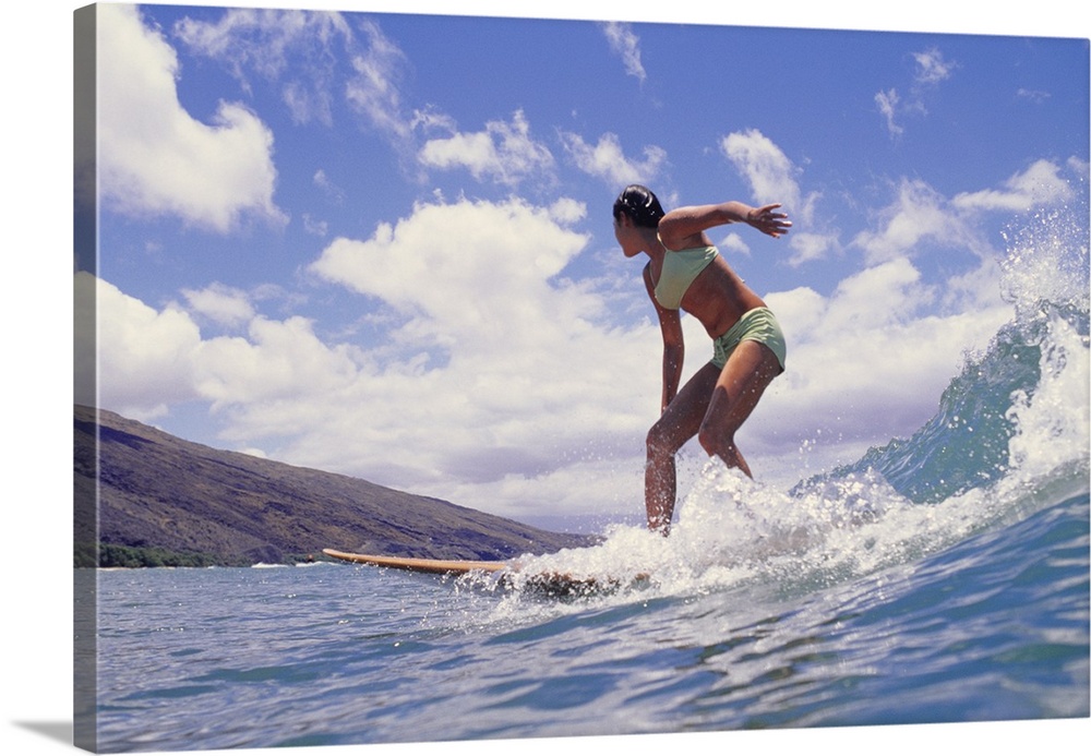 Woman surfing on ocean wave, low angle view