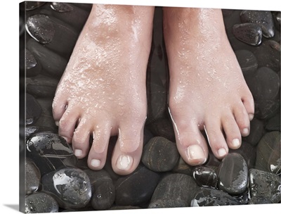 Woman's feet on pebbles