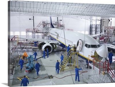 Workers in airplane hangar