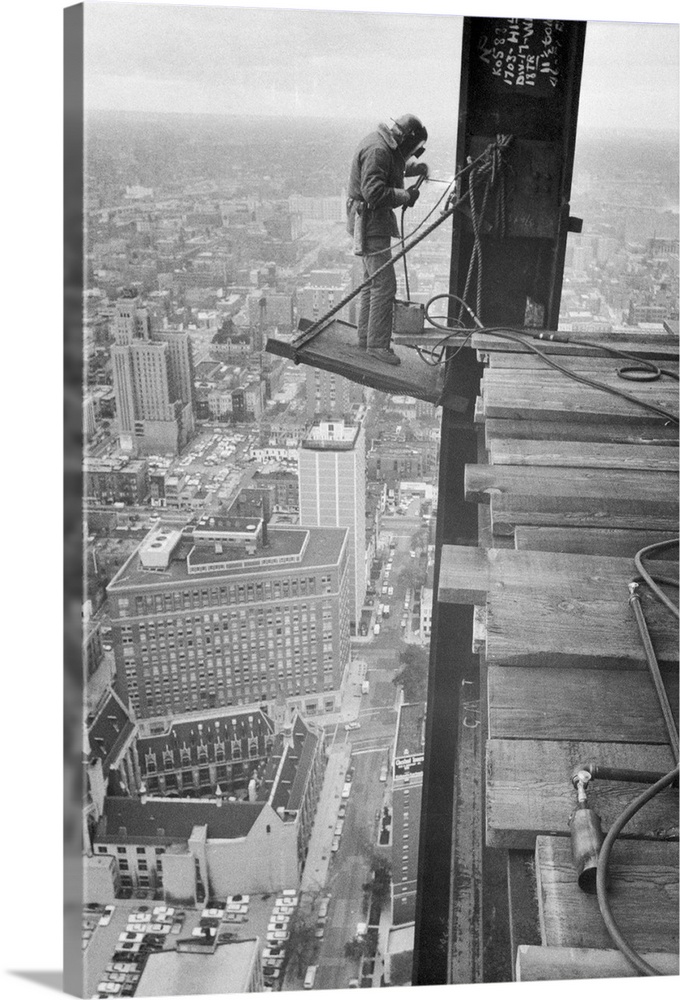 High Up. Chicago, Illinois: High above Chicago, Charles White has a job that few persons would want, as he welds steel bea...