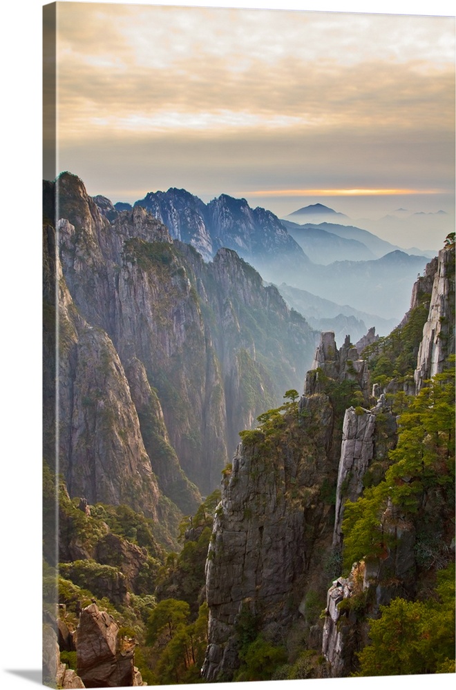 Scenery with peculiarly shaped granite peaks, Huangshan pine trees and views of clouds from above.