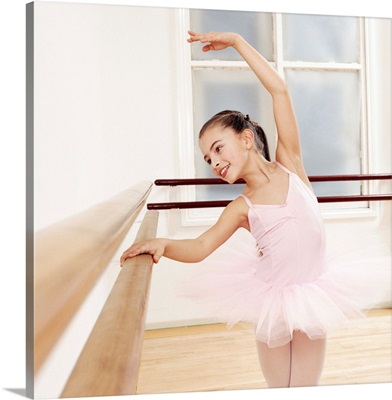 Young Girl in a Tutu Practises Ballet in a Studio