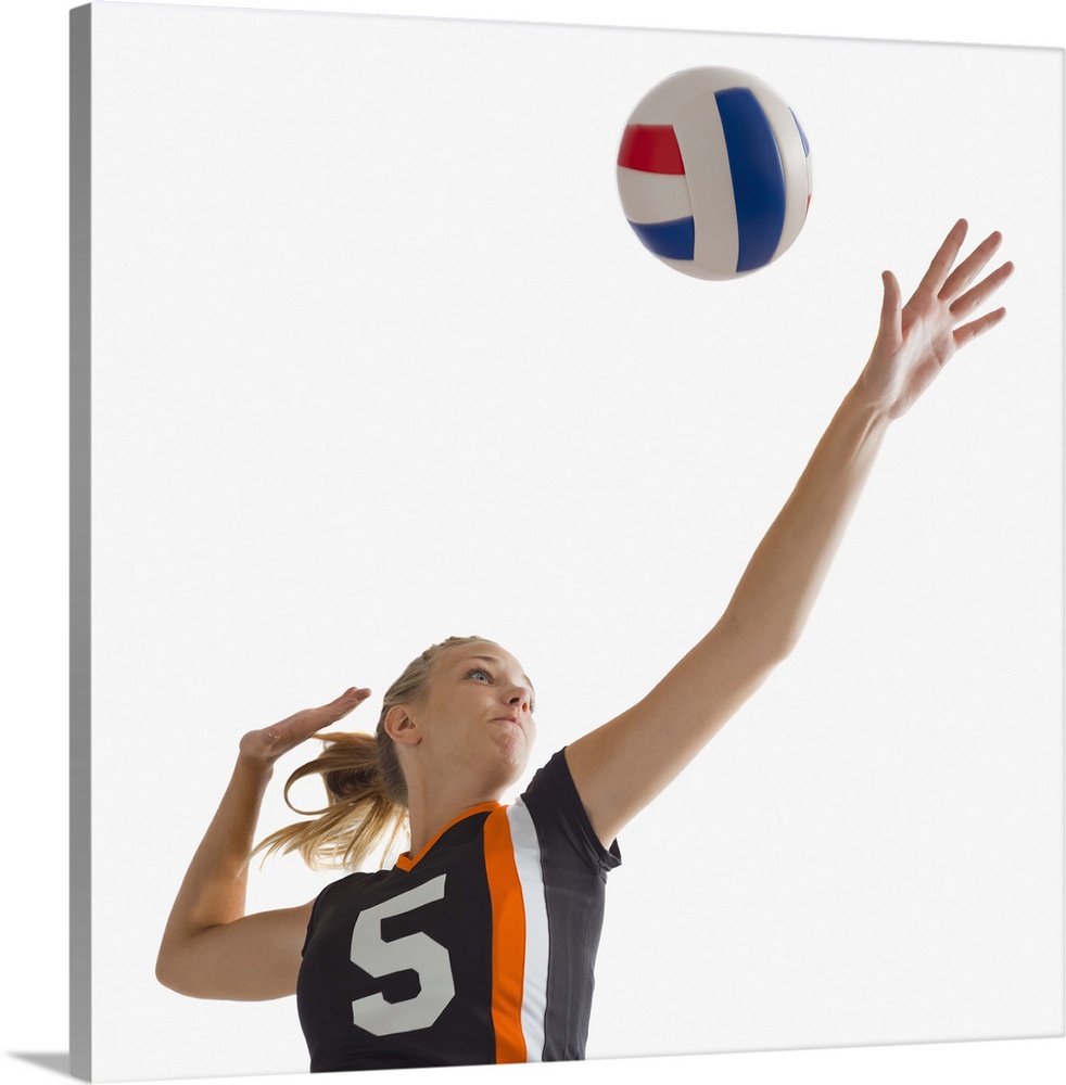 Young girl (16-17) playing volleyball