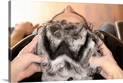 Young man getting his hair washed at a hair salon