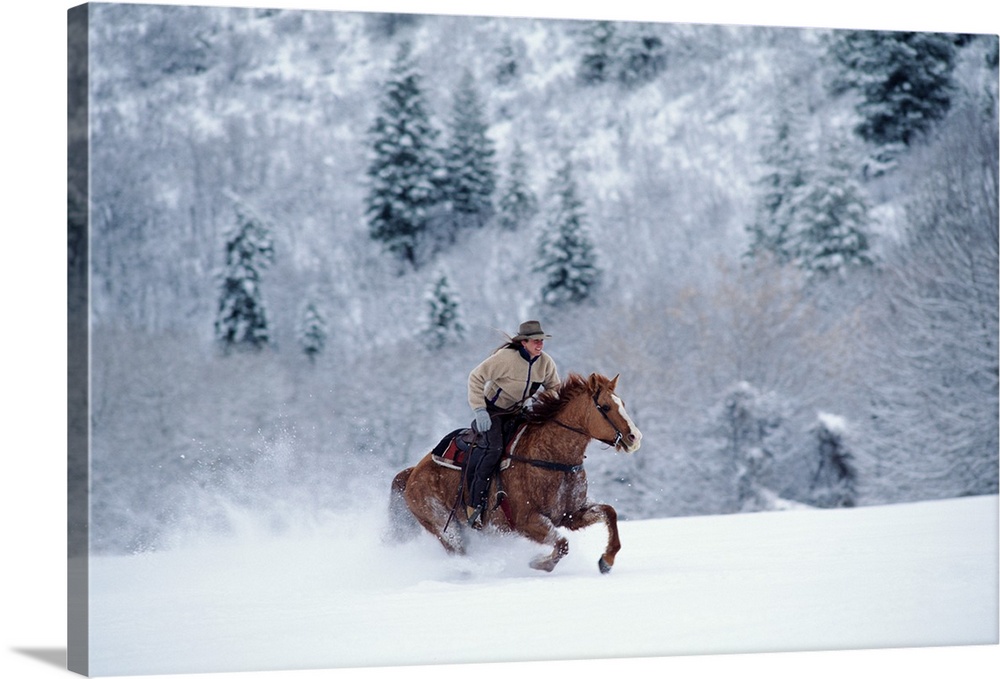 YOUNG WOMAN WINTER HORSEBACK RIDE IN WEST COLORADO