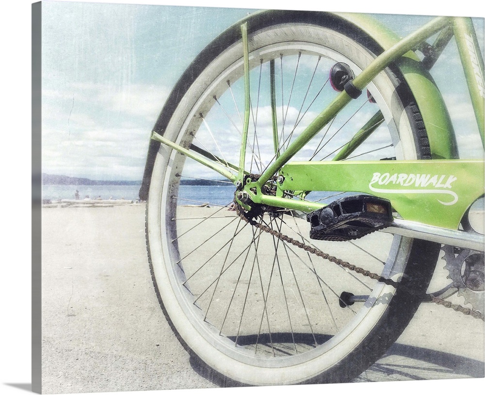 Aged photograph of the rear of a green bicycle with a slightly blown out beach scene in the background.