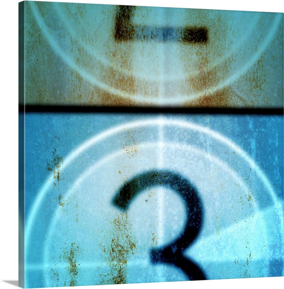 Square, large vintage wall hanging of a filmstrip countdown that is between two and three, covered with dark age spots.