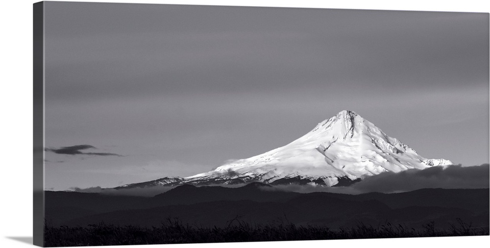 A black and white photograph of a Mt. Hood under a smooth gray sky.