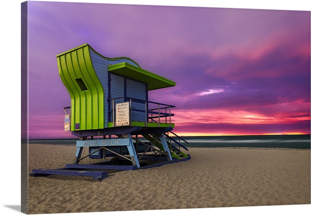 Sunrise paints storm clouds over Miami Beach's retro 18th Street lifeguard station.