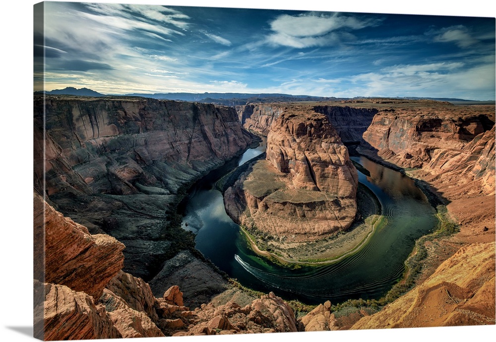 A boat rounds the tip of the iconic Horseshoe Bend near Page, Arizona.