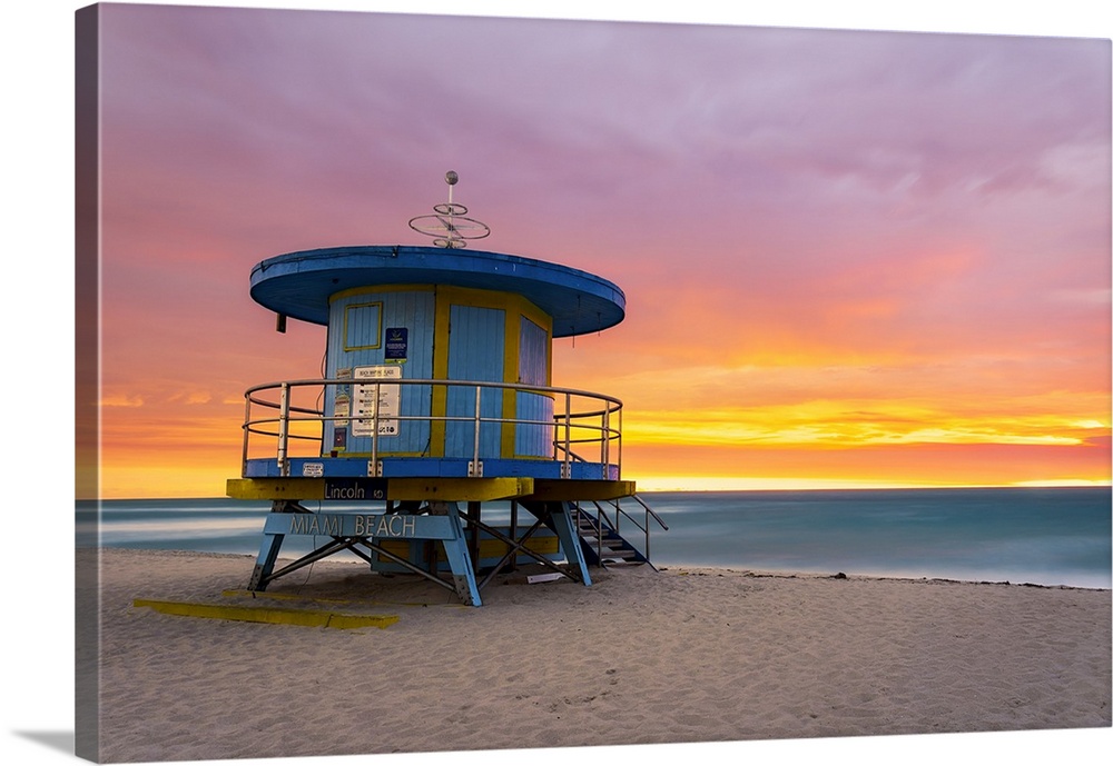 Clouds above the Lincoln Road Lifeguard station on Miami's South Beach lights up just before the sun breaches the eastern ...