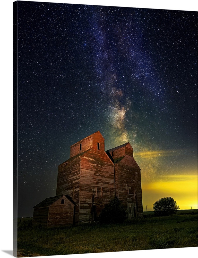 The Milky Way glows behind an old grain elevator in the ghost town of Arena, North Dakota.