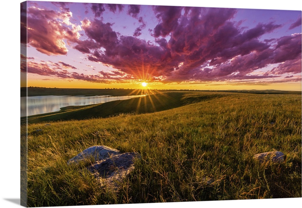 Sunset over South Dakota's Lake Oahe is spectacular, with clouds turned crimson and beautiful light cast over the rolling ...