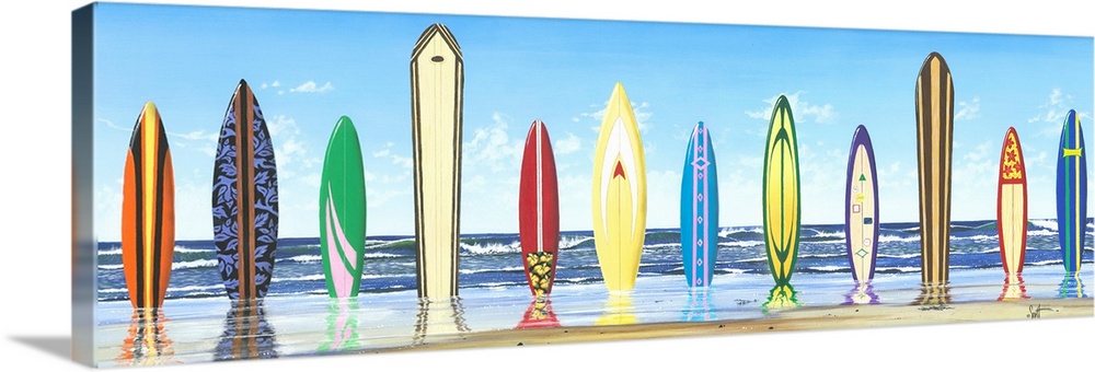 Panoramic photograph of color surfboards standing in sand with the ocean in the background.