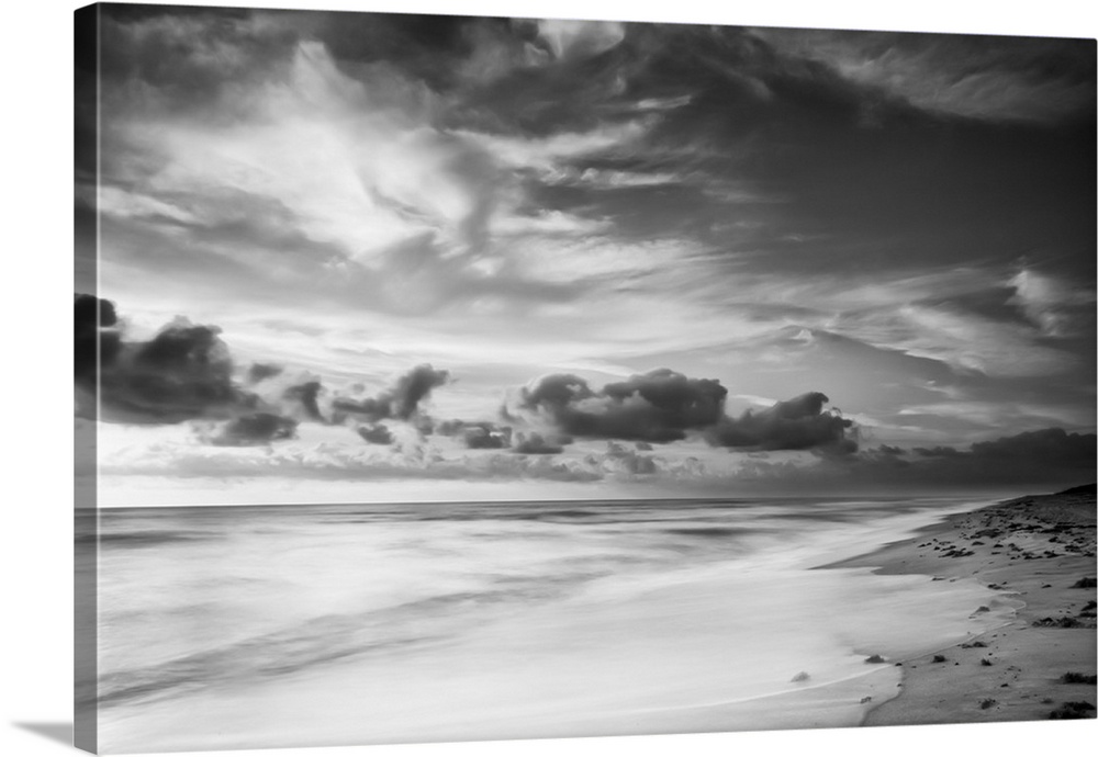 A black and white photograph of a sunrise sky with clouds obscuring the view.