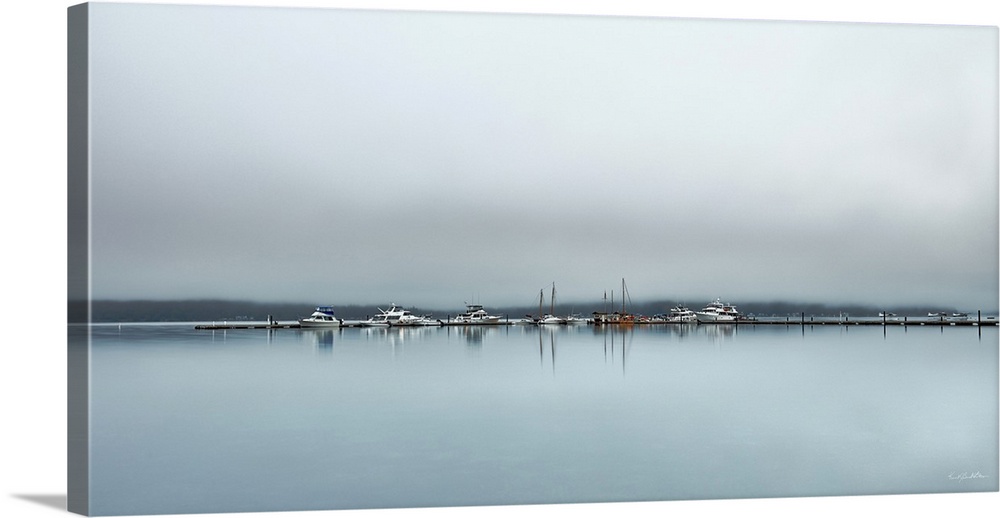 Fog blankets boats and float planes at the Alderbrook Marina just as the sunrises for the day.
