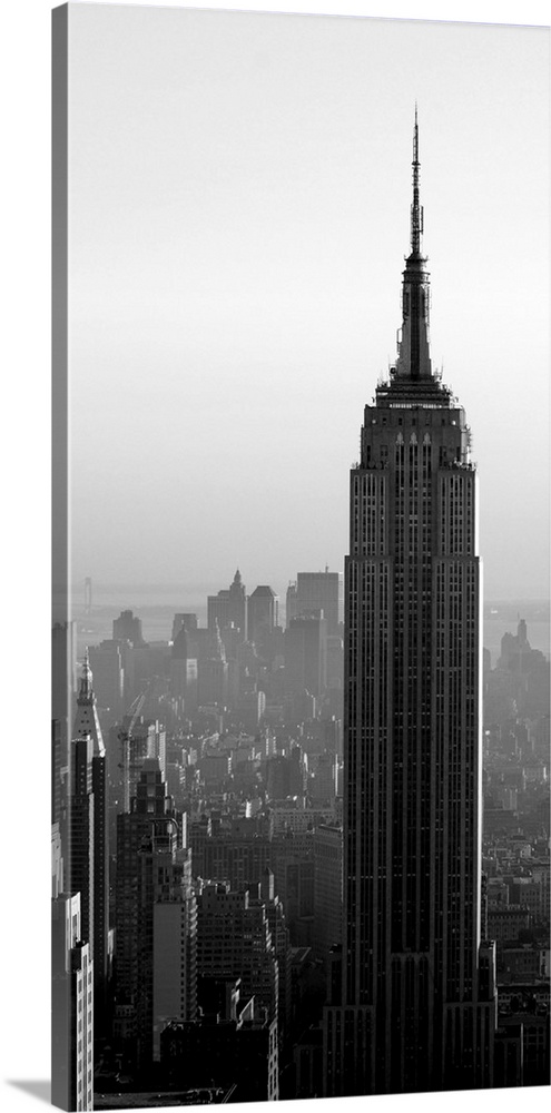 A long vertical black and white image of the Empire States Building in New York City.