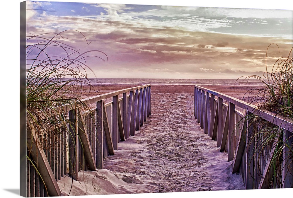Fenced sandy walkway on St. Augustine Beach at sunset.