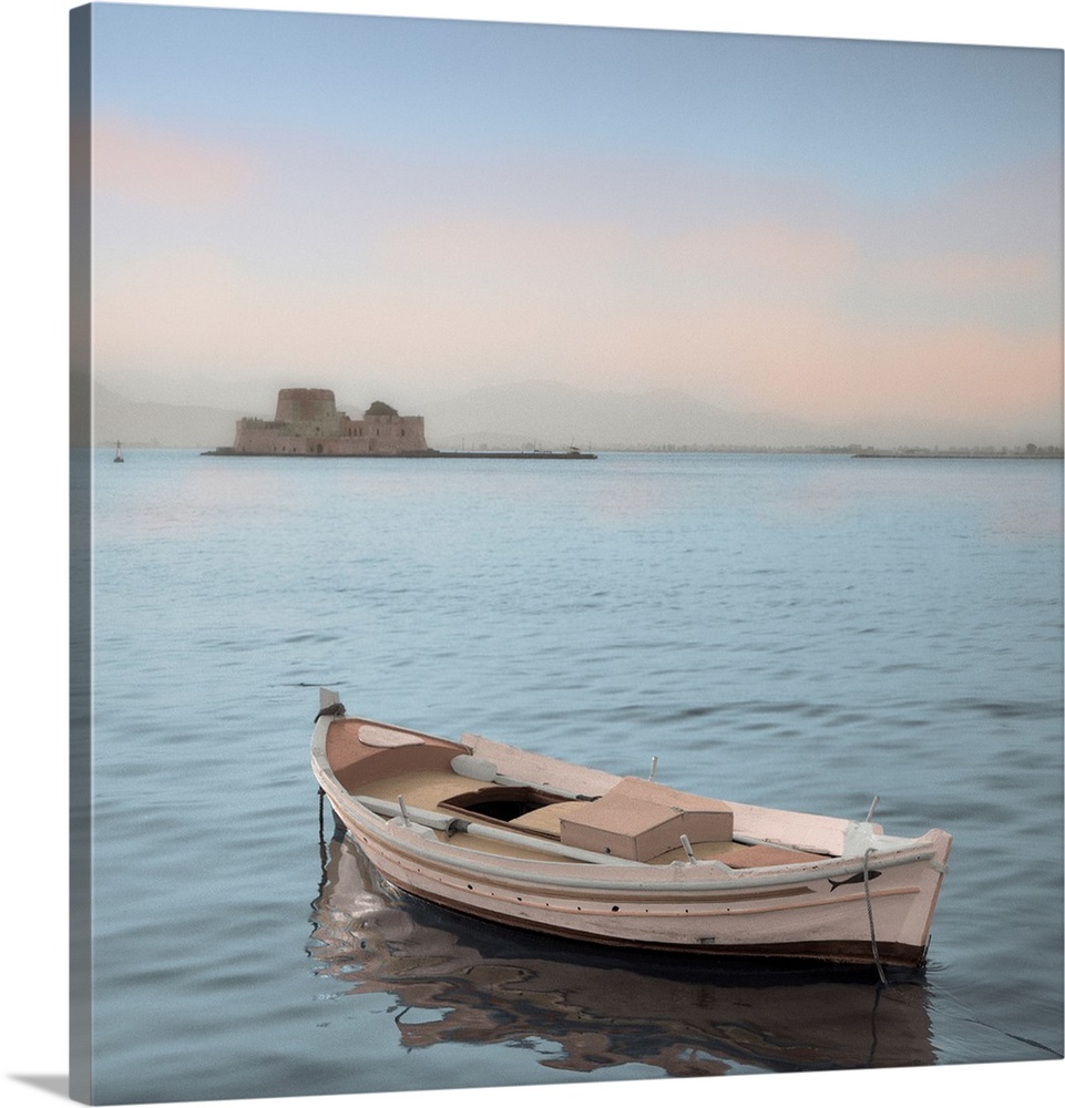 A single boat floating in the calm waters of the Mediterranean with a nearby castle in the background.