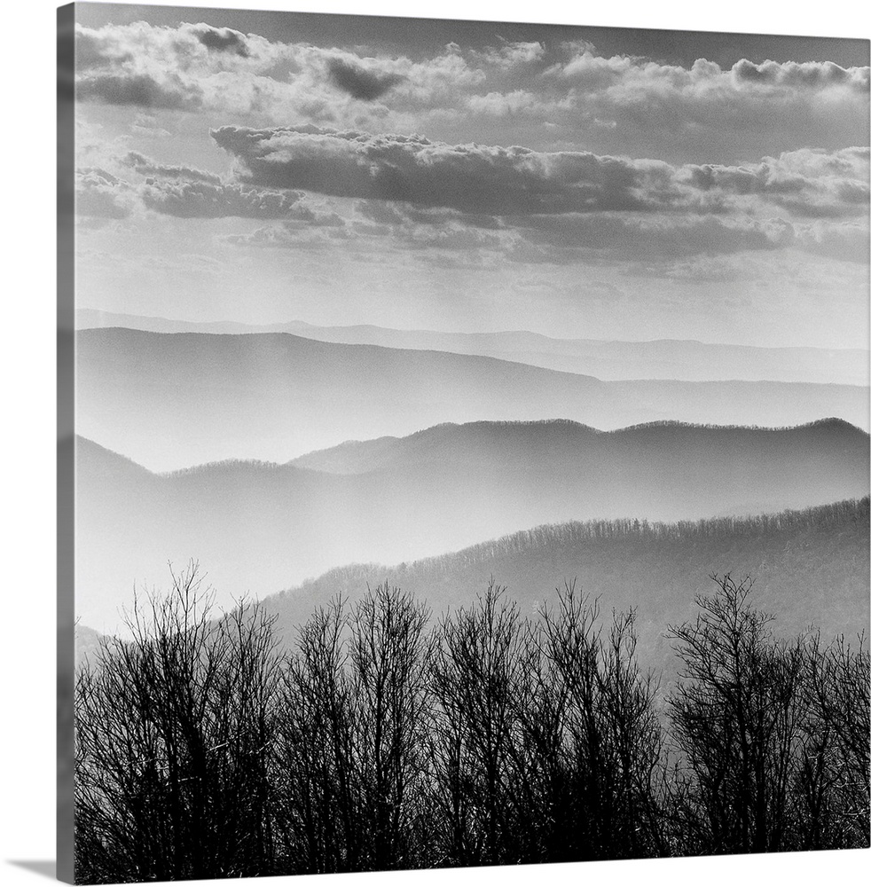 Square black and white image of the rolling mountains of the Blue Ridge with mist and layers of clouds.