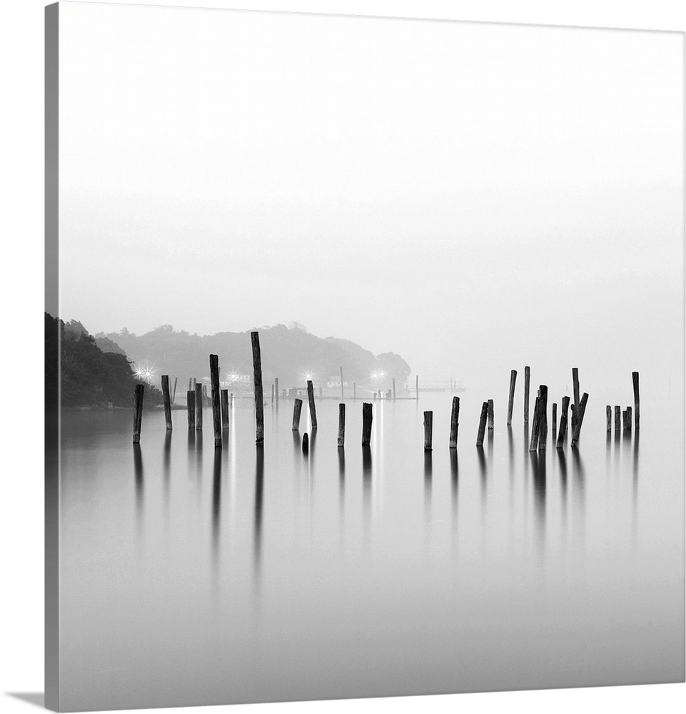 Black and white square image of an old pier in mist.