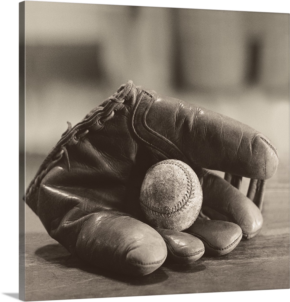 Photograph in sepia tones of a baseball mitt with a baseball by Judy B. Messer.