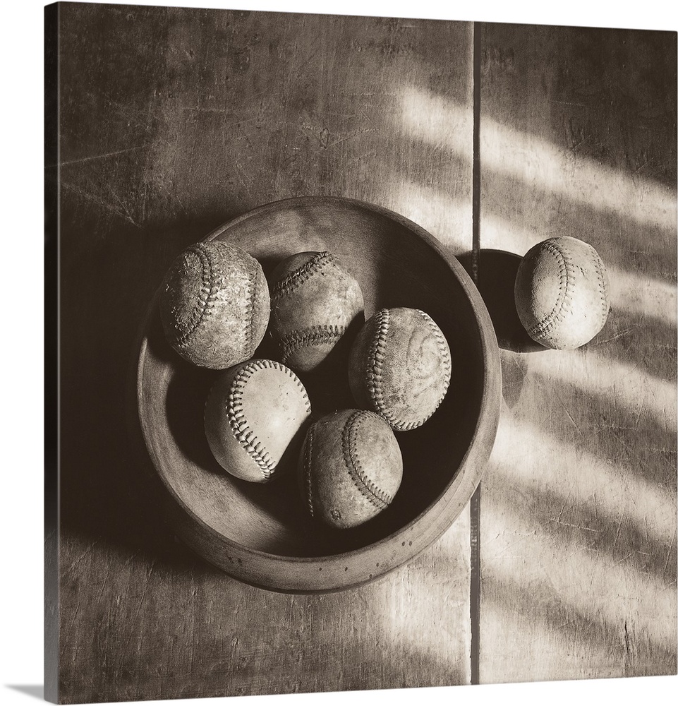 Photograph in sepia tones of a bowl of baseballs by Judy B. Messer.