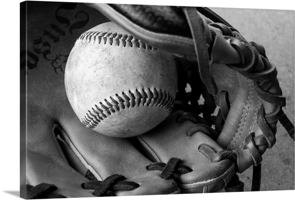 Detail shot of a baseball and baseball glove.