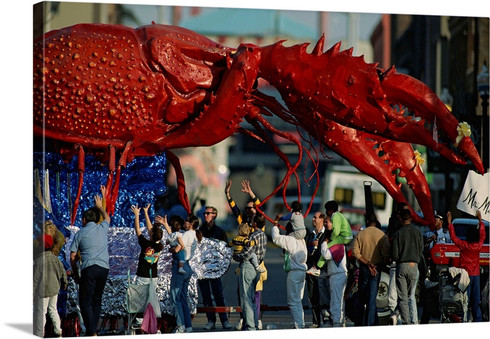 Louisianans revel beneath a giant crayfish Mardi Gras float.