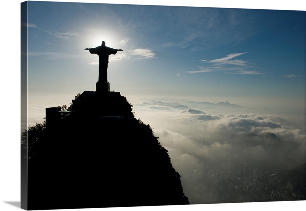 Christ the Redeemer Statue at sunrise above the clouds.