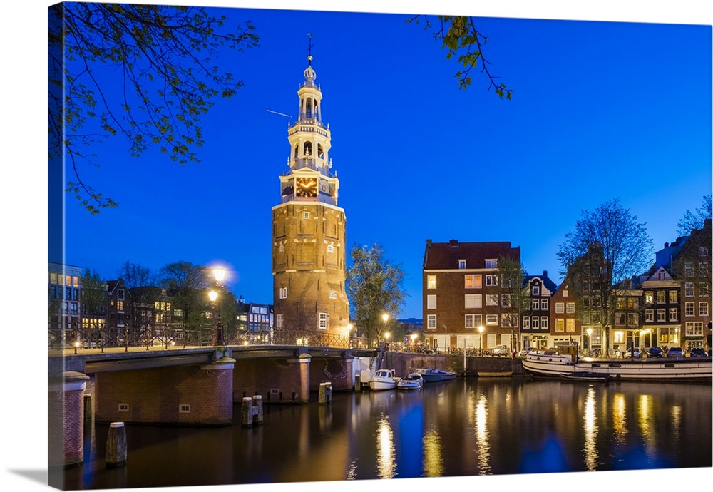 Netherlands, North Holland, Amsterdam. 16th century Montelbaanstoren tower on Oudeschans canal.