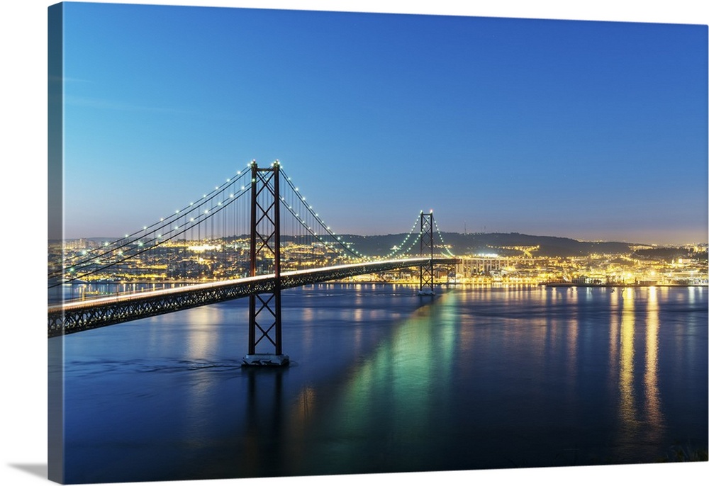 25th of April Bridge over the Tagus river (Tejo river) and Lisbon at twilight. Portugal.