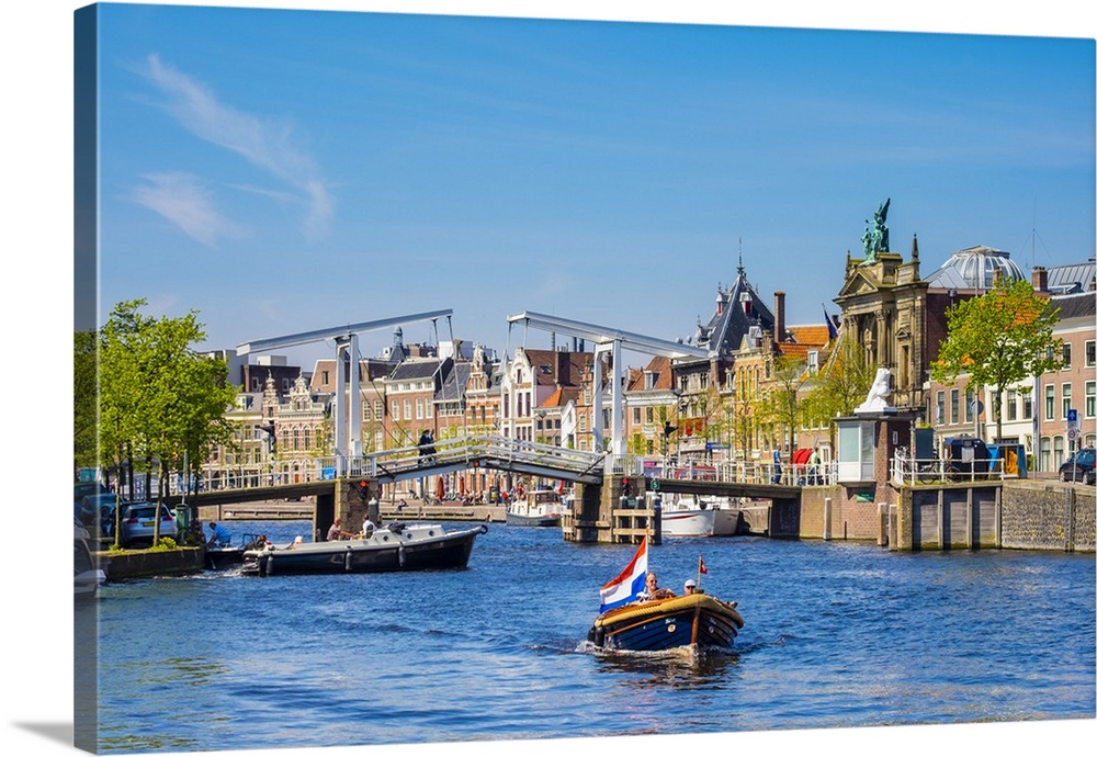 Netherlands, North Holland, Haarlem. A boat in front of the Gravestenenbrug drawbridge on the Spaarne River.