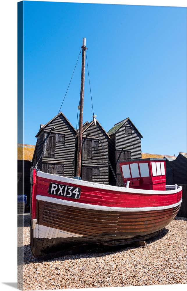 A fishing boat and the net shops - a weather-proof storage for the fishing gear, Hasting Old Town, Sussex, England.