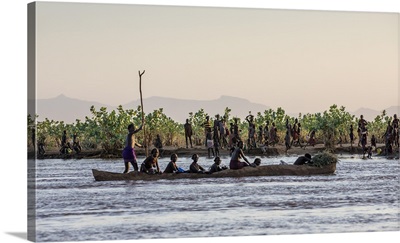A large dugout canoe ferries Dassanech people across the Omo River, Ethiopia