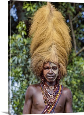 A Maasai warrior wears a headdress made from a lion's mane during an eunoto ceremony