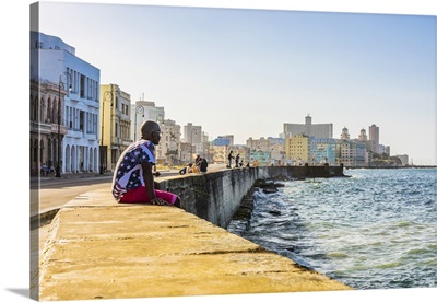 A Man Sitting And Watching The Ocean From The Malecon, Havana, Cuba