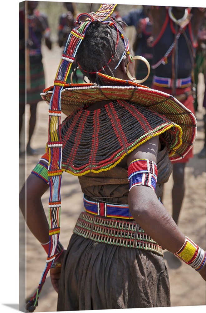 A Pokot woman in traditional attire dances to celebrate an Atelo ceremony. Her broad belt is made with the metacarpus and ...