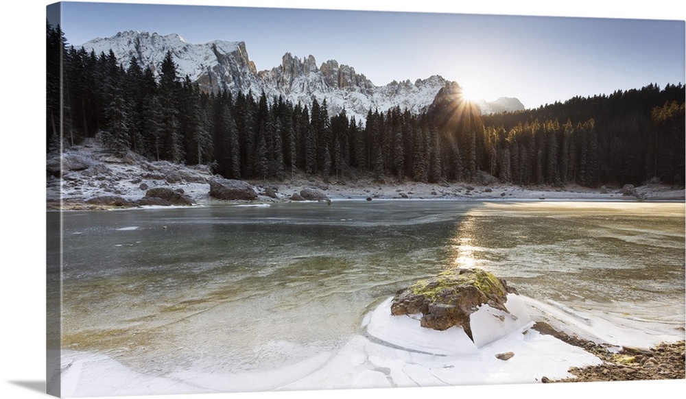 A suggestive sunset at Karersee where the last sun reflected on the iced lake, Bolzano province, South Tyrol, Trentino Alt...