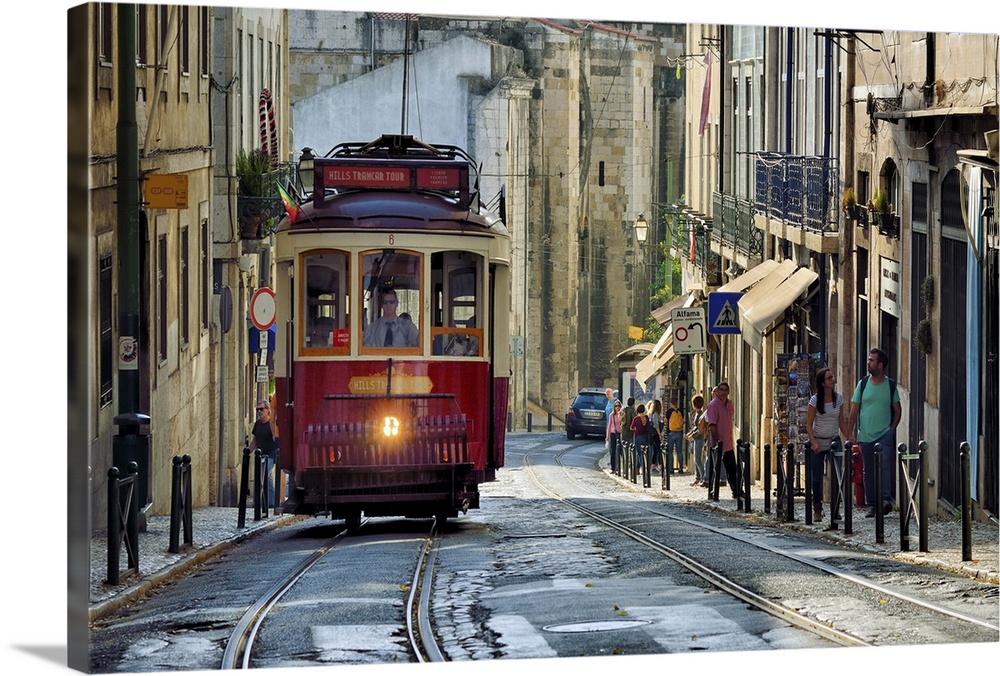 A tramway in Alfama district with the Motherchurch (Se Catedral) in the background. Lisbon, Portugal.
