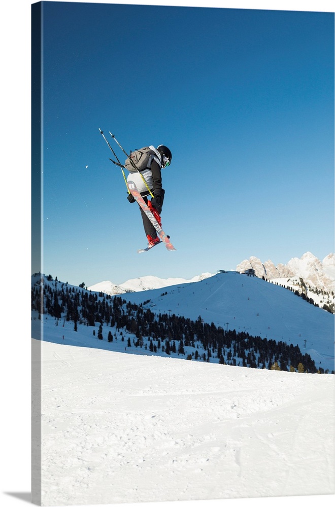 A View Of A Freestyler Flying With His Skis After A Jump In Val Gardena, Bolzano Province, South Tyrol, Trentino Alto Adig...