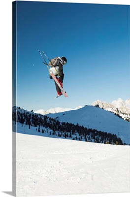 A View Of A Freestyler Flying With His Skis After A Jump In Val Gardena, Italy