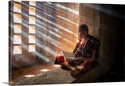 A Young Monk Reading By A Window Inside A Temple, UNESCO, Bagan, Myanmar