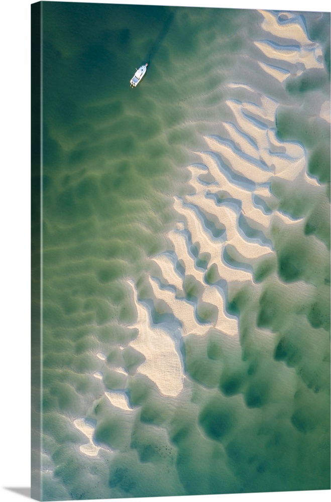 Aerial view of a boat moored on the Camel Estuary at low tide, Rock, Cornwall, England. Summer (July) 2022.