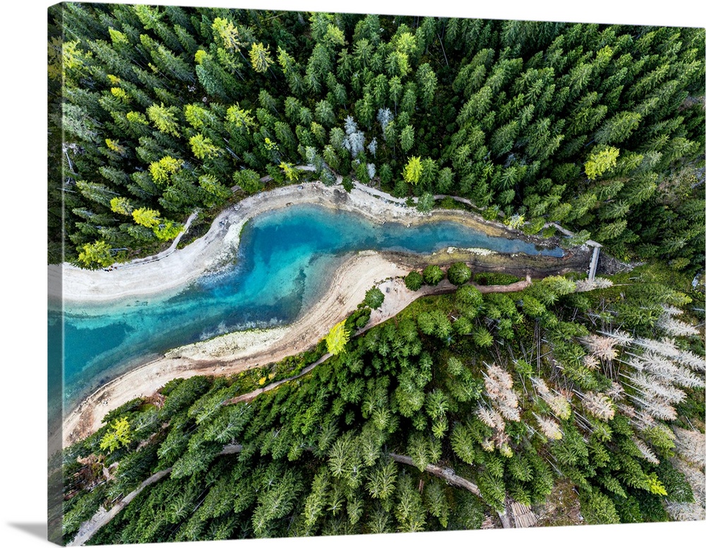 Aerial view of the turquoise colored water of Lake Braies / Pragser Wildsee in a lush autumn forest, Dolomites, South Tyro...
