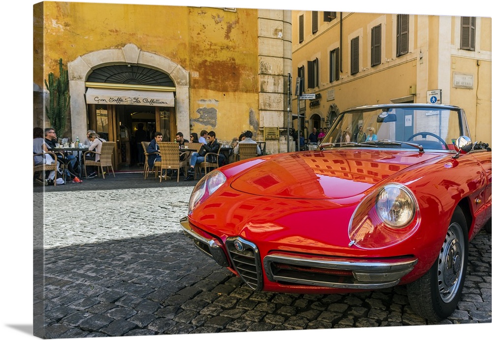 Alfa Romeo Duetto spider parked in a cobblestone street of Rome, Lazio, Italy.