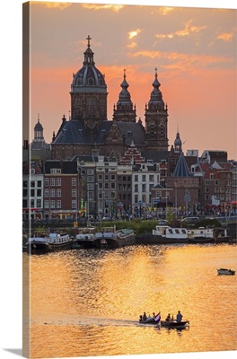 Amsterdam city skyline at sunset with domes of Basilica of Saint Nicholas